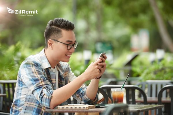 Professional using mobile phone for Philippines payments